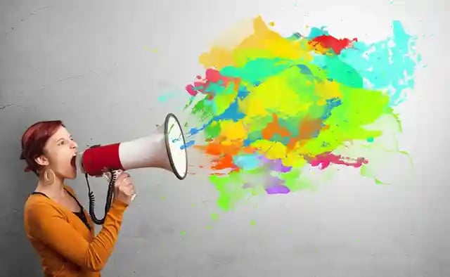 Person with megaphone and colorful splashes