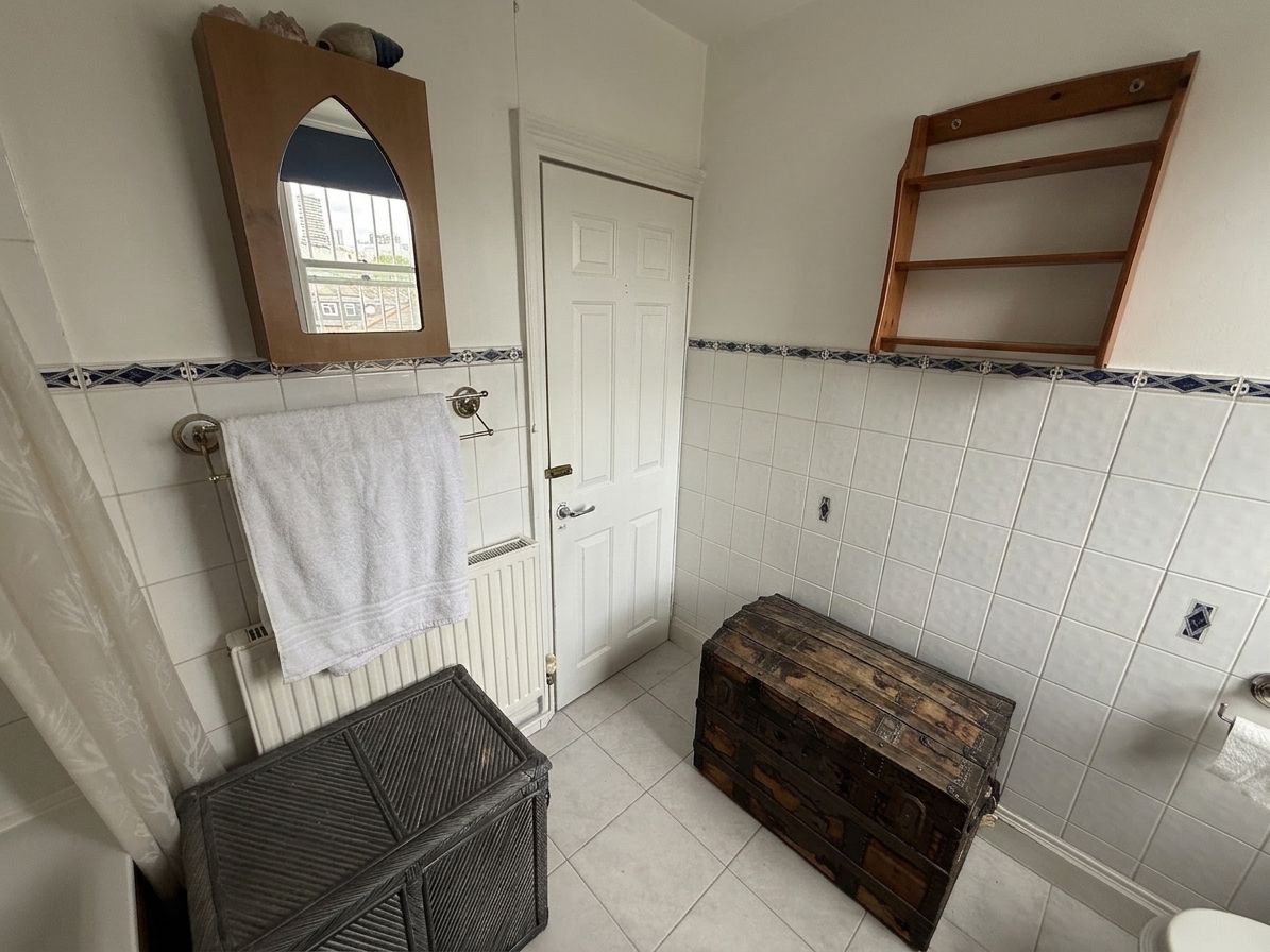 Family bathroom towards the door (digitally staged)