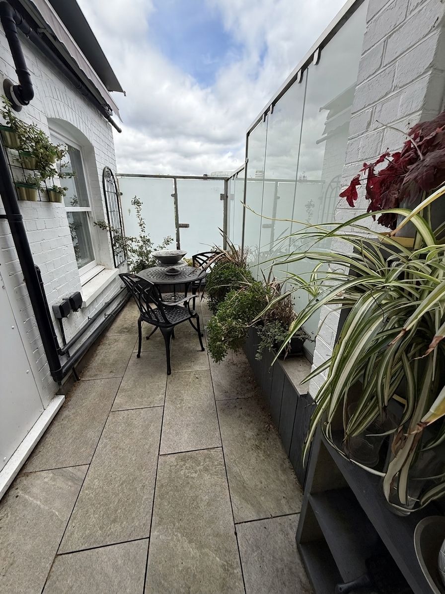 The glass-enclosed patio (digitally staged)