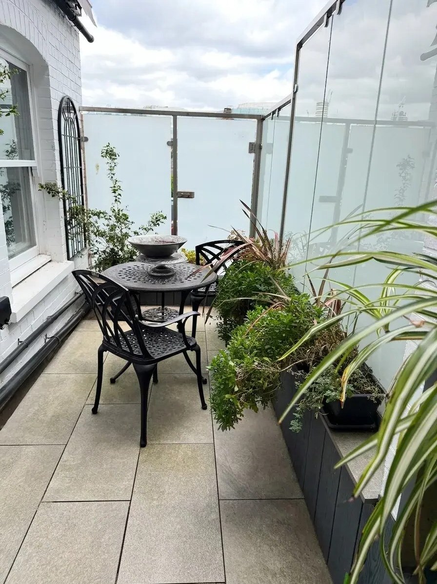 The glass-enclosed patio (digitally staged)